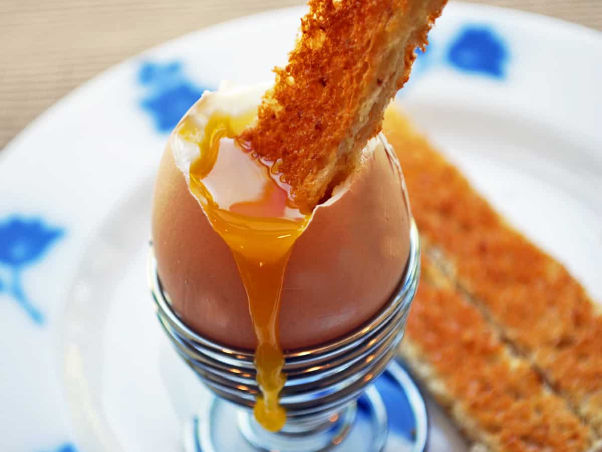 A toast soldier dipped into a soft-boiled egg. 