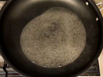 Wine simmers in a skillet.