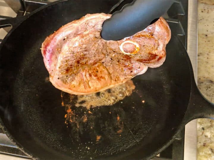 Searing the steak on the edges.