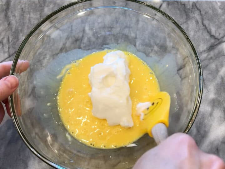 Folding the egg whites into the yolks.