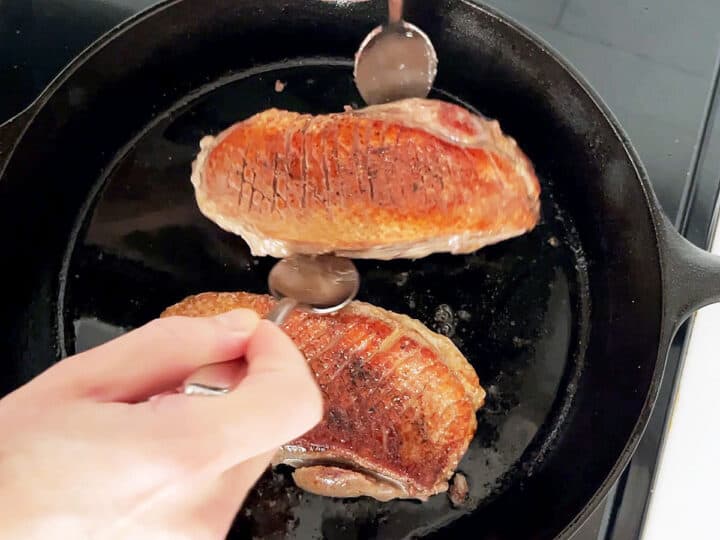 Flipping the duck in the skillet.