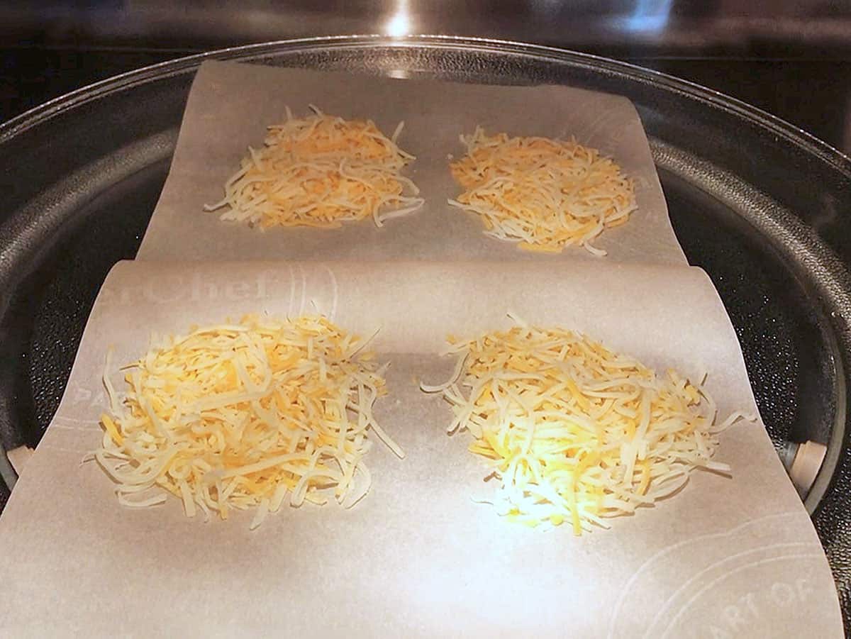 Placing the mounds of cheese in the microwave.
