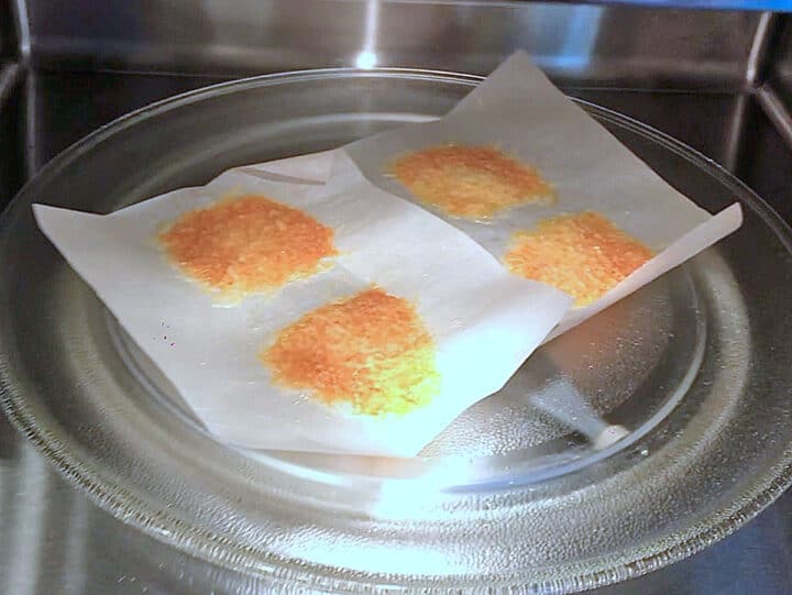 The cheese crackers are ready inside the microwave.