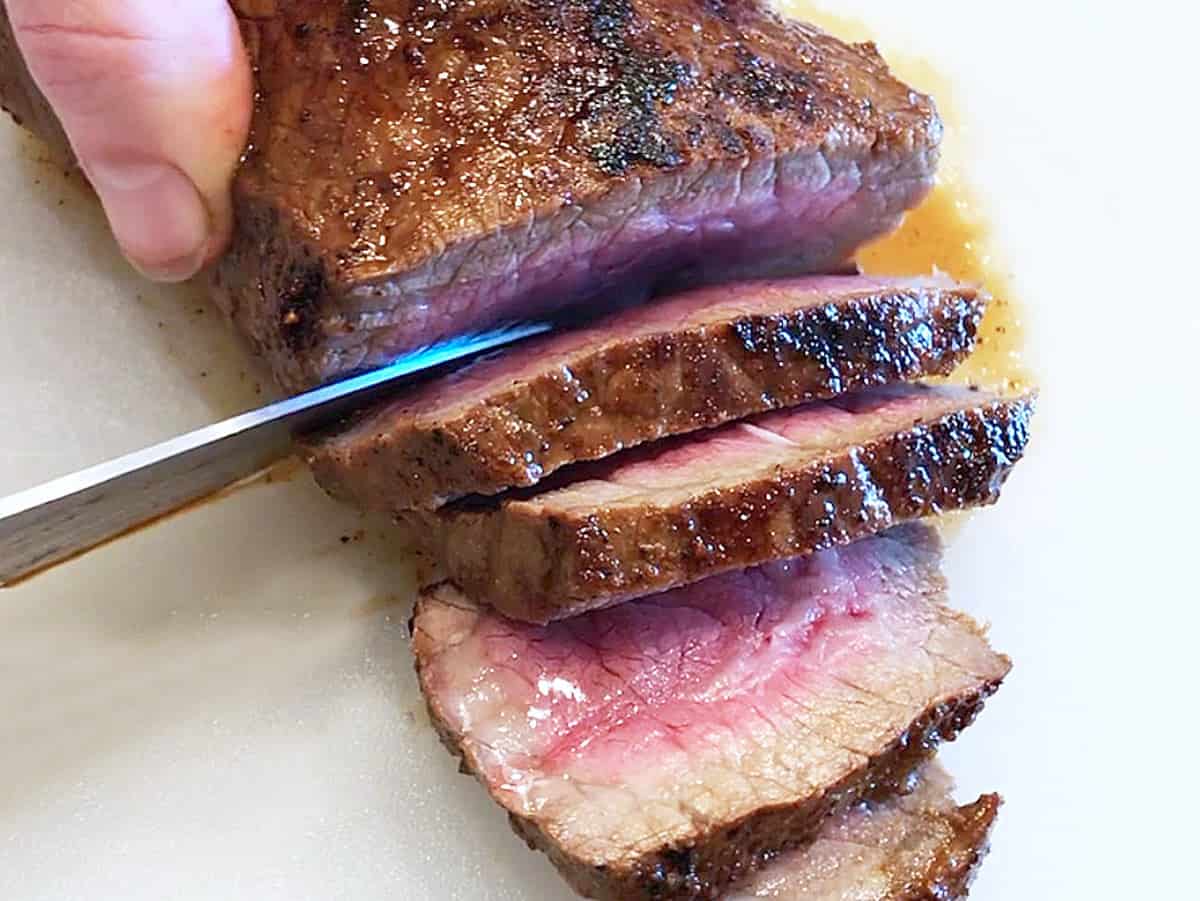 Slicing a London broil steak.