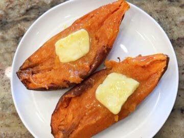Microwave sweet potato is served topped with butter.