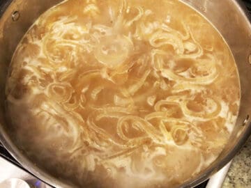 Bringing onion soup to a boil.