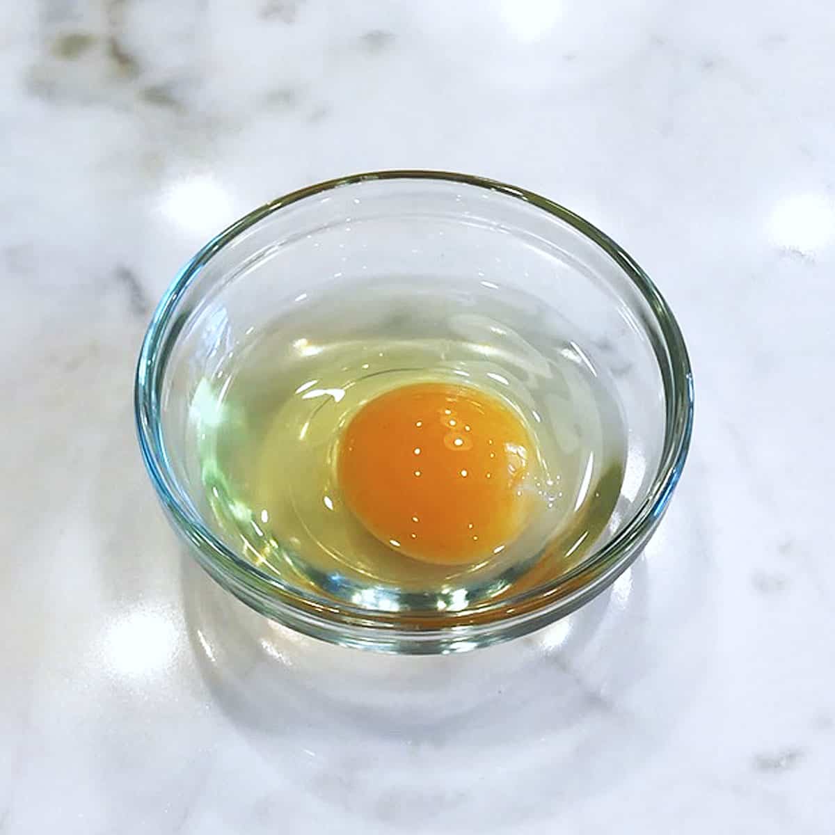 An egg in a small bowl.