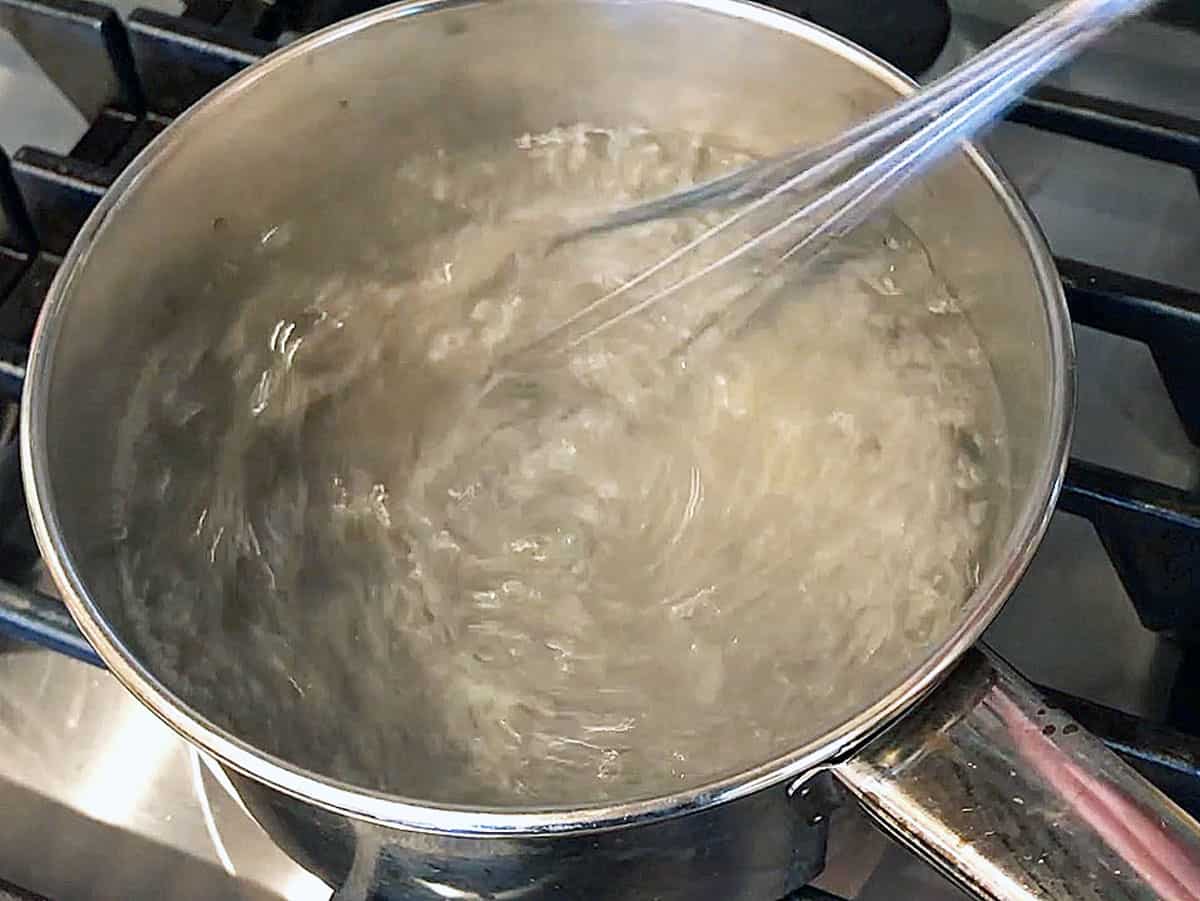 Whisking the boiling water.