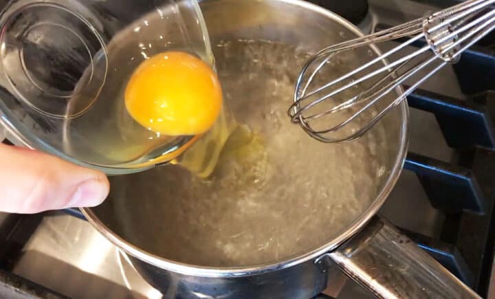 Pouring the egg into the water.