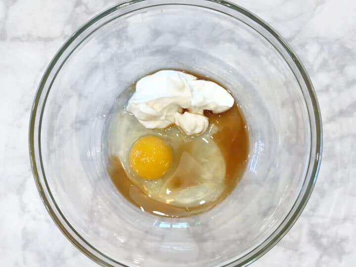 Egg, vanilla, stevia, and Greek yogurt in a bowl.
