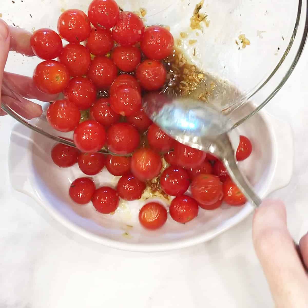 Transferring the tomatoes to a baking dish.