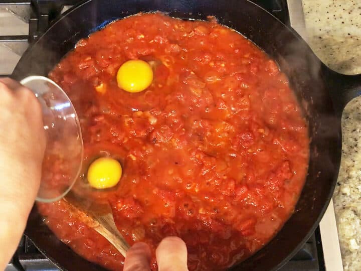 Adding eggs to the skillet.