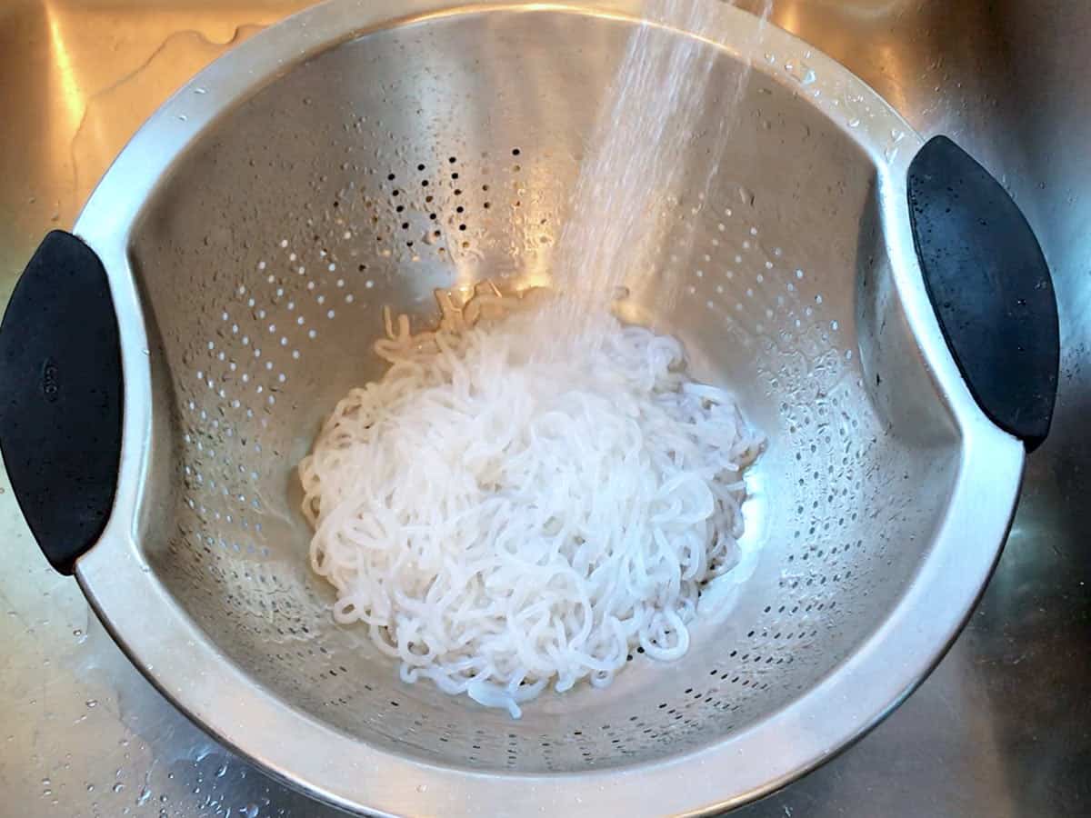 Rinsing the noodles before cooking them.