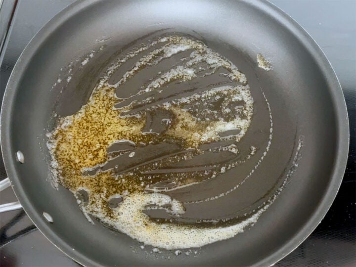 Cooking the brown butter sauce in a skillet.