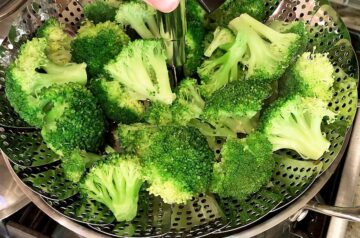 The steamed broccoli is ready in the steamer basket.