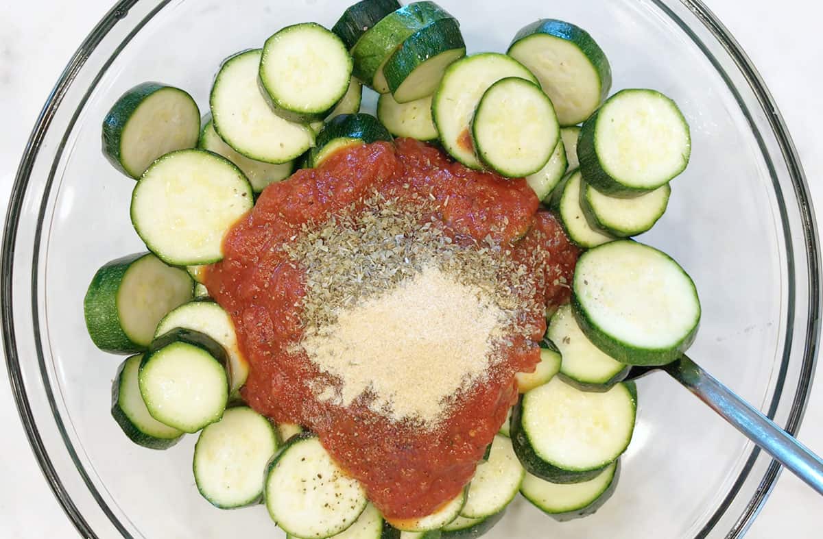 Adding spices to the zucchini.