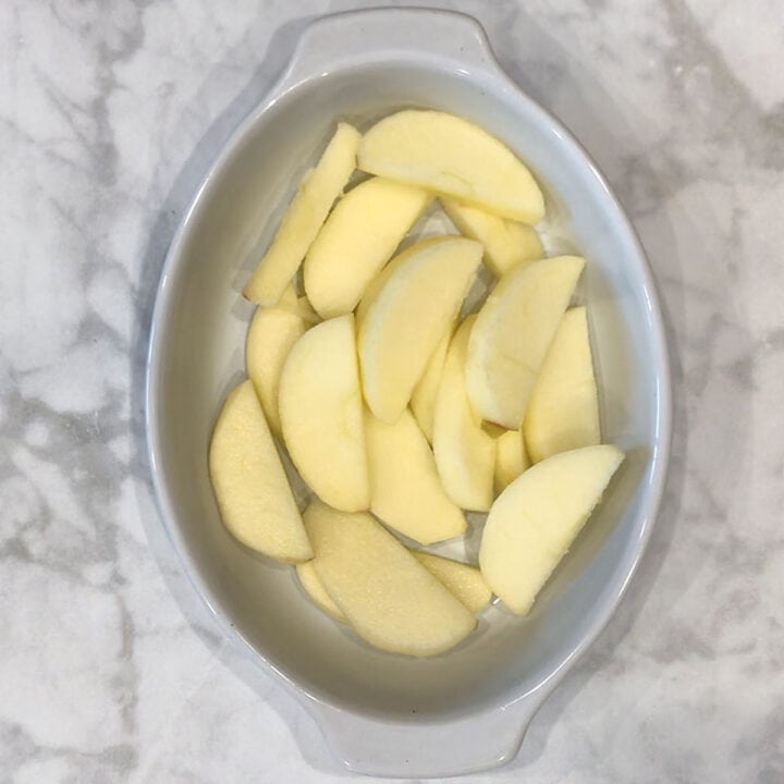 Apple slices in a baking dish.