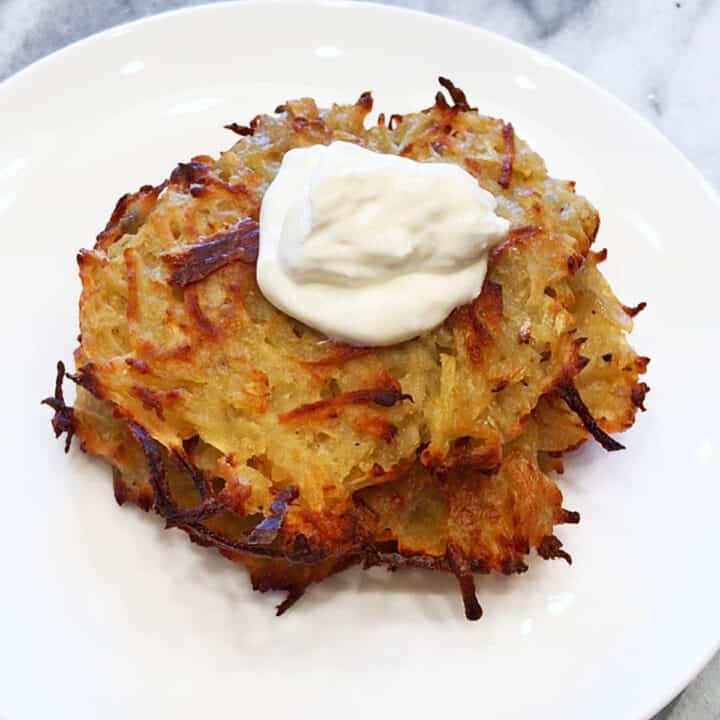 Baked latkes topped with sour cream.