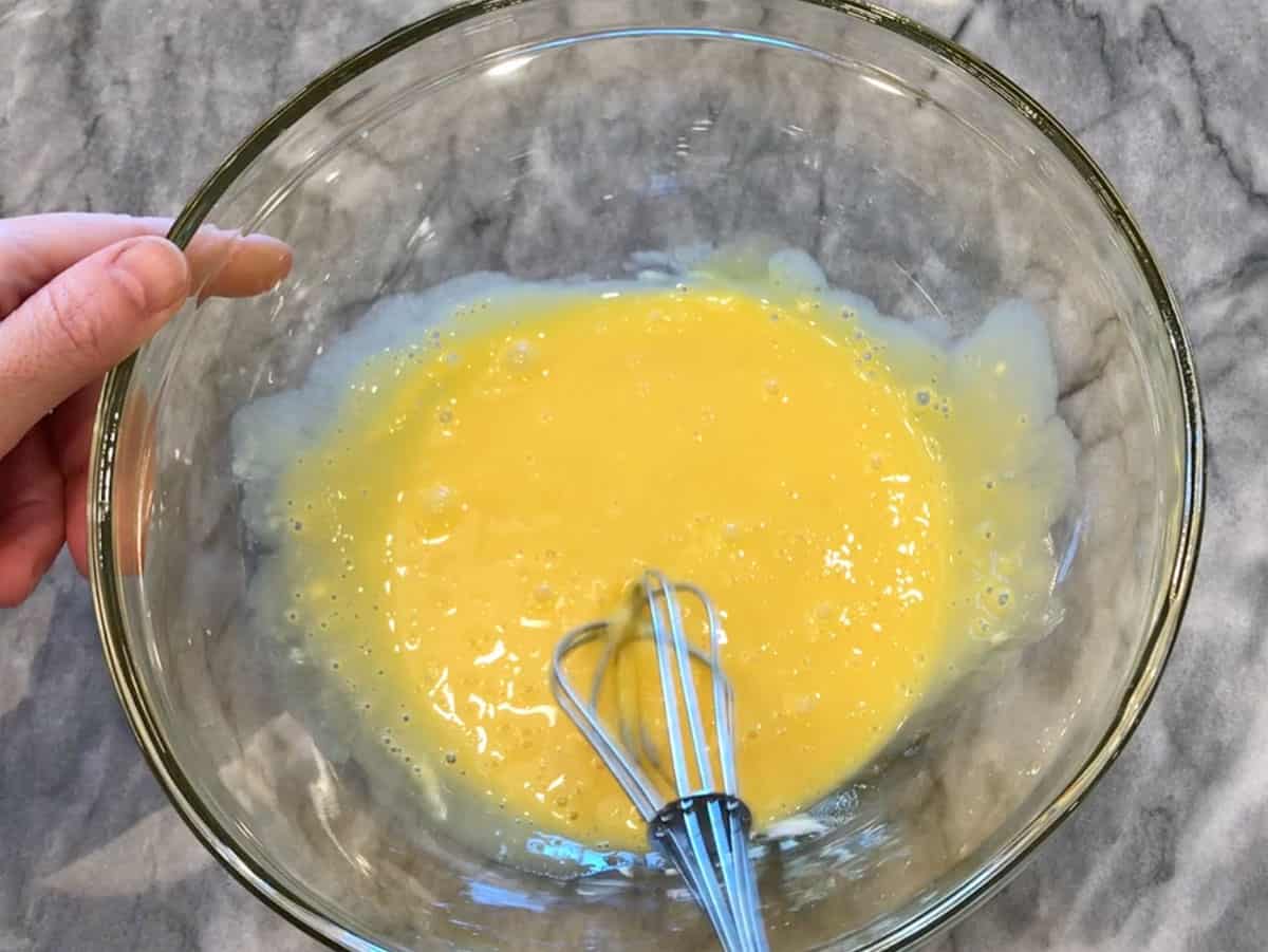 Mixing egg yolks, yogurt, and salt.