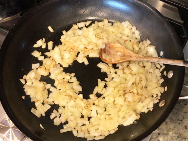 Cooking onions in a skillet.