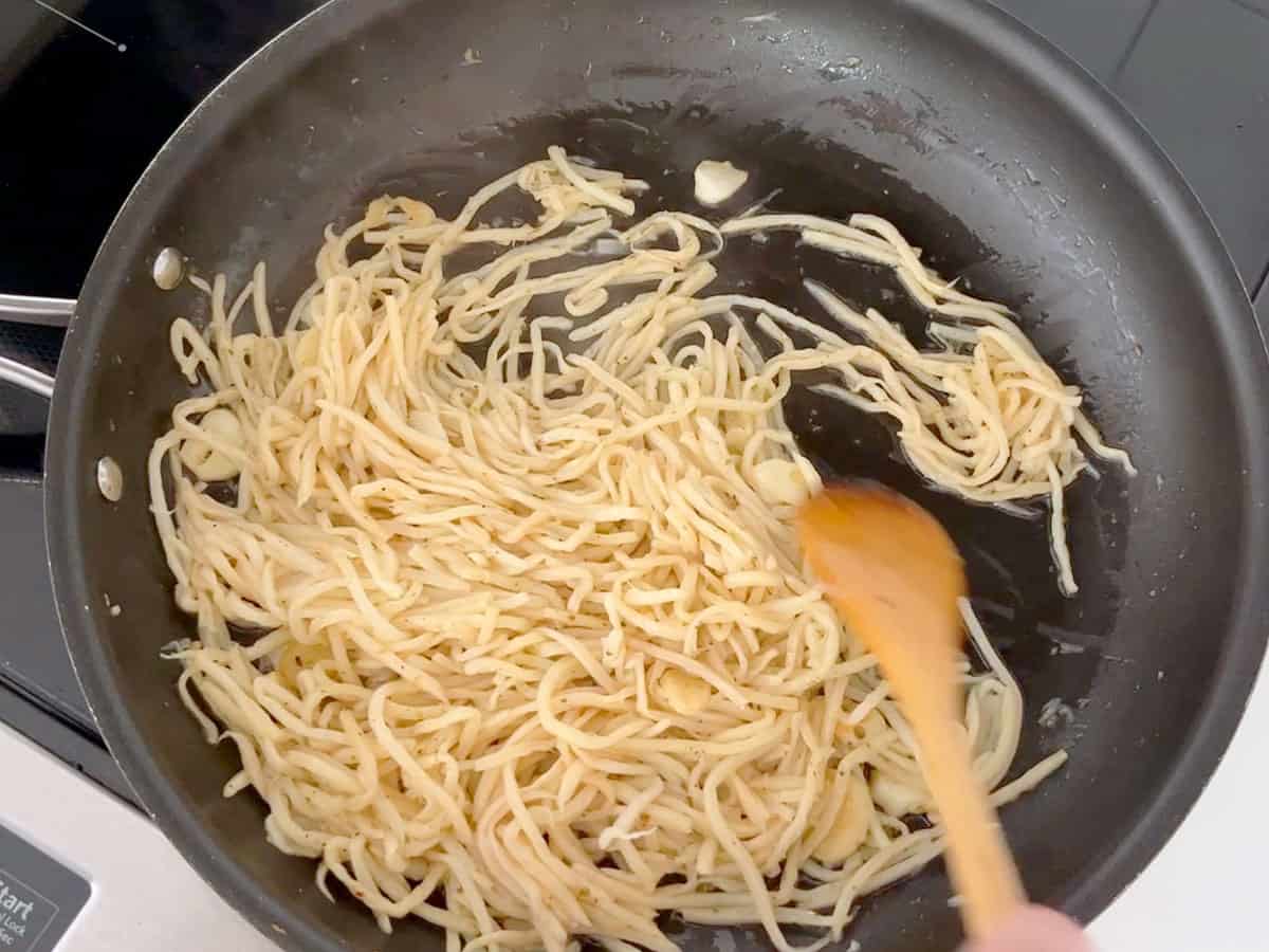 Cooking the pasta in a skillet.