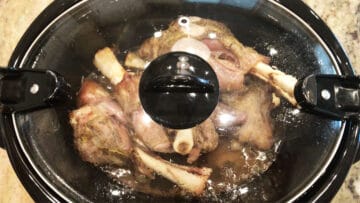 Cooked lamb shanks in the slow cooker.