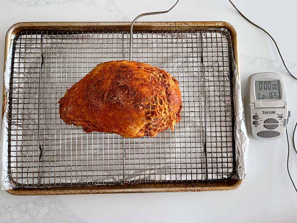 A meat thermometer inserted into the turkey.