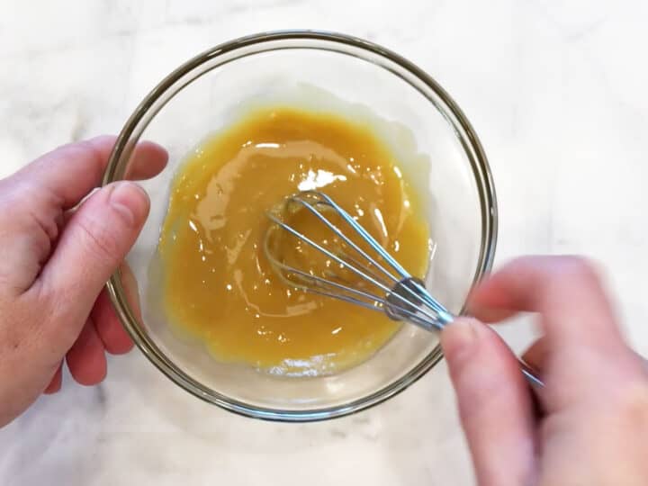 Mixing honey and mustard in a small bowl.