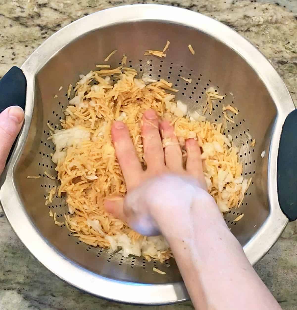 Removing liquid from the potatoes and onions.