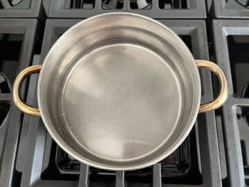 A saucepan with water on the stove.