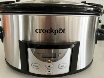 A slow cooker set to WARM.