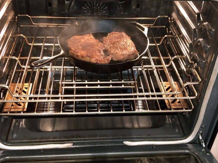 Placing the steaks in the oven.