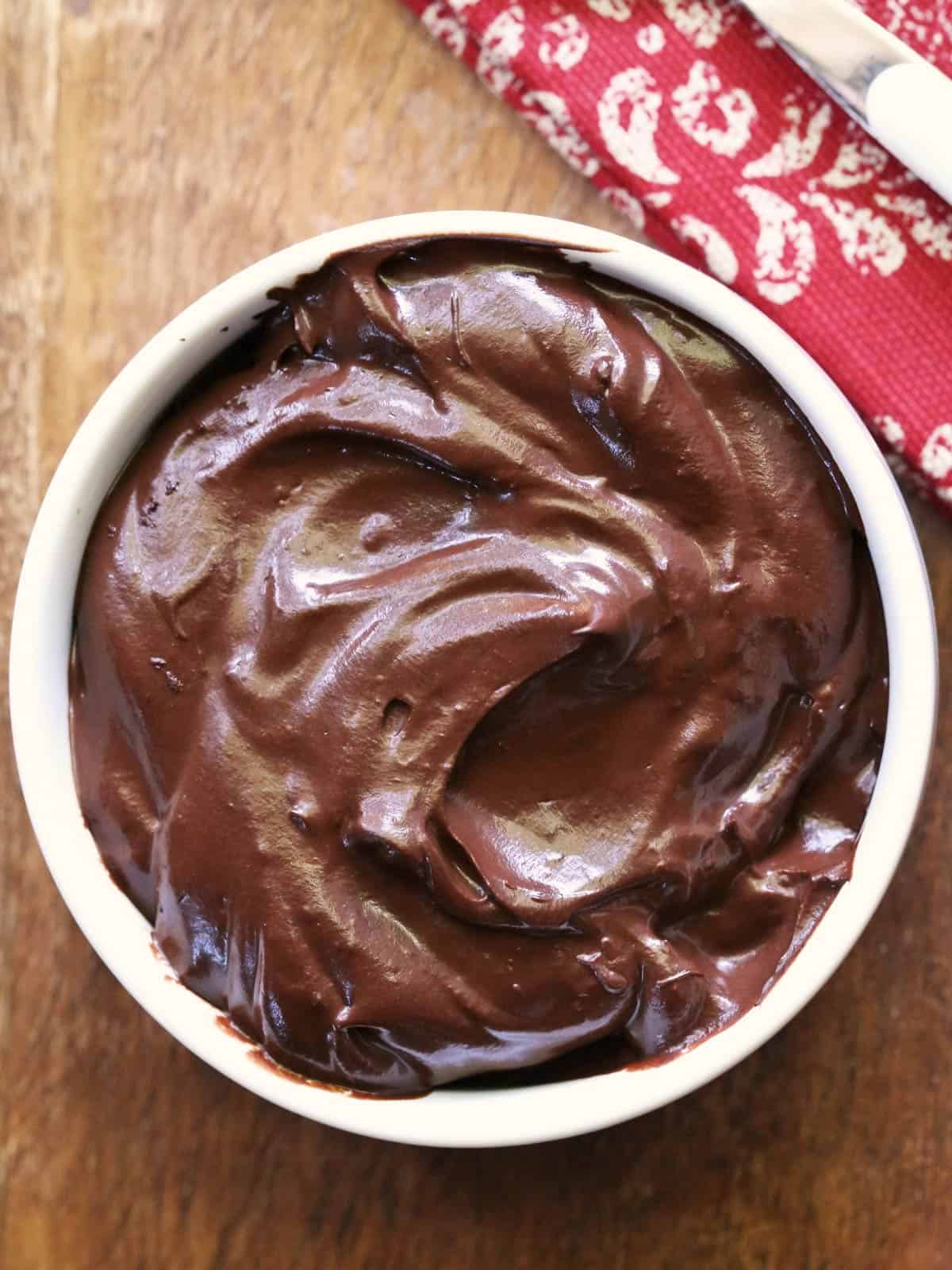 Avocado chocolate mousse is served in a white bowl.