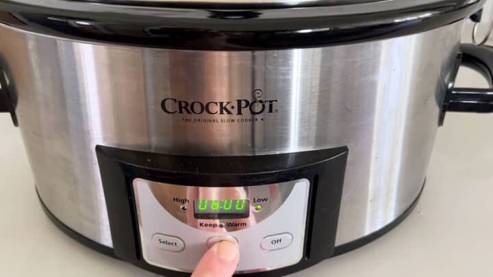 Setting the slow cooker to six hours.