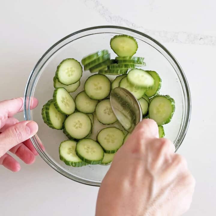 Mixing the salad in a bowl.