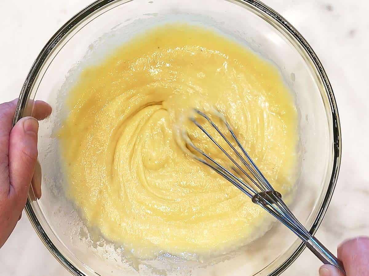 Mixing almond flour into the batter.