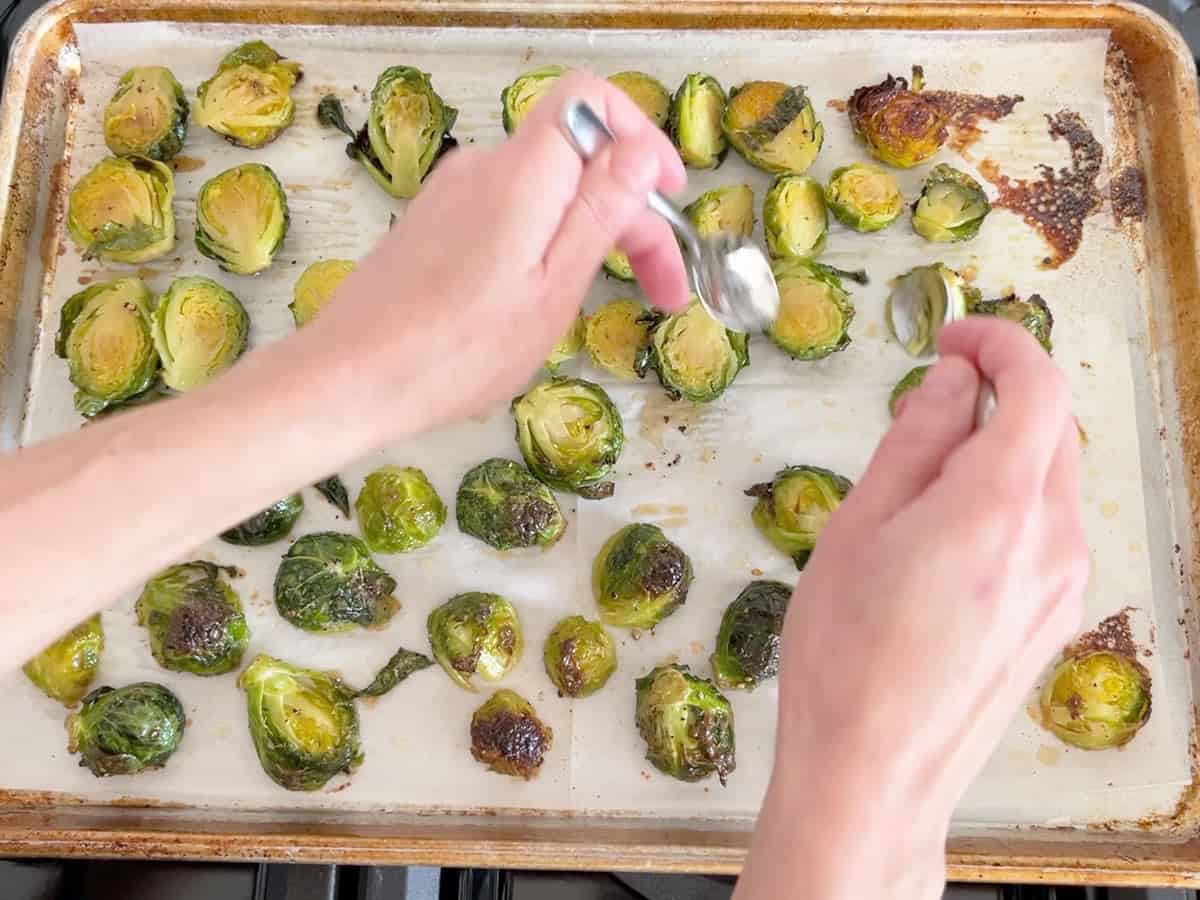 Flipping the sprouts in the pan.