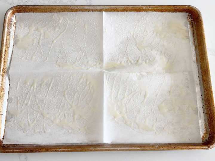 A rimmed baking sheet lined with parchment paper and sprayed with oil.