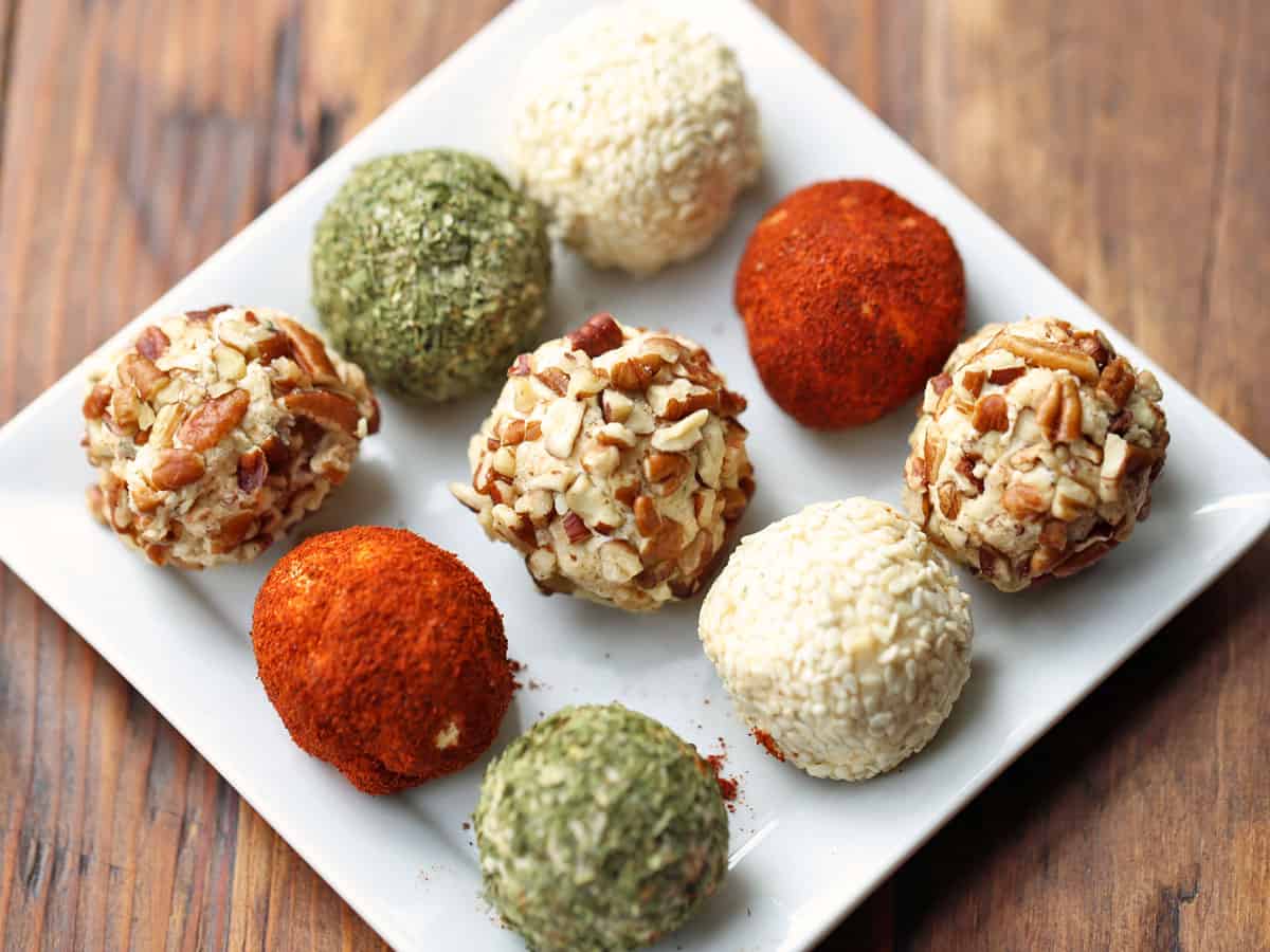 Cheese balls coated in spices, nuts, and sesame seeds.