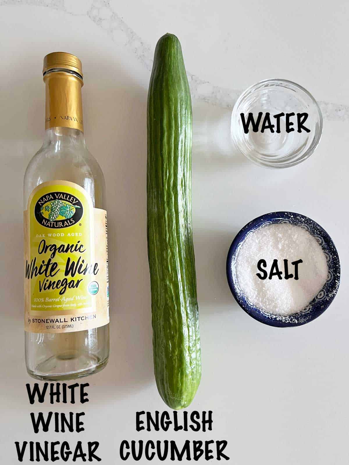 The ingredients needed to make a cucumber vinegar salad.