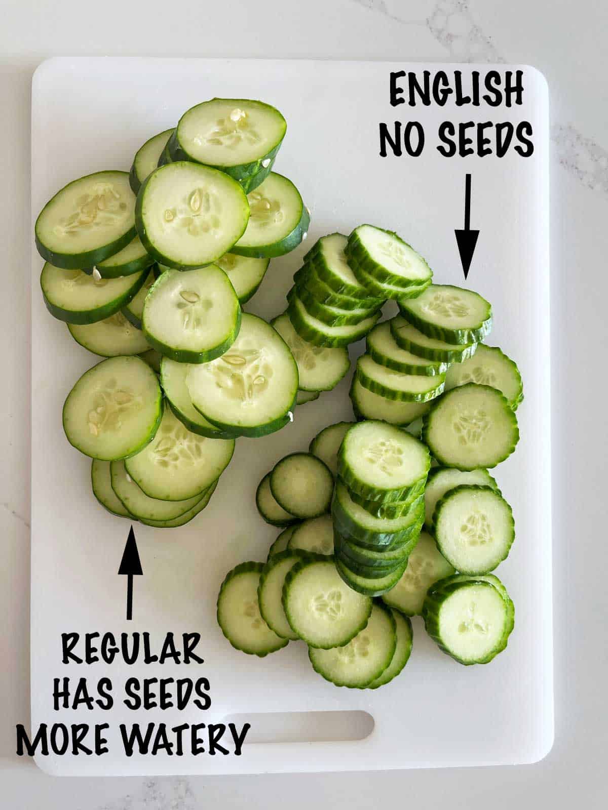 A sliced regular cucumber next to a sliced English cucumber.