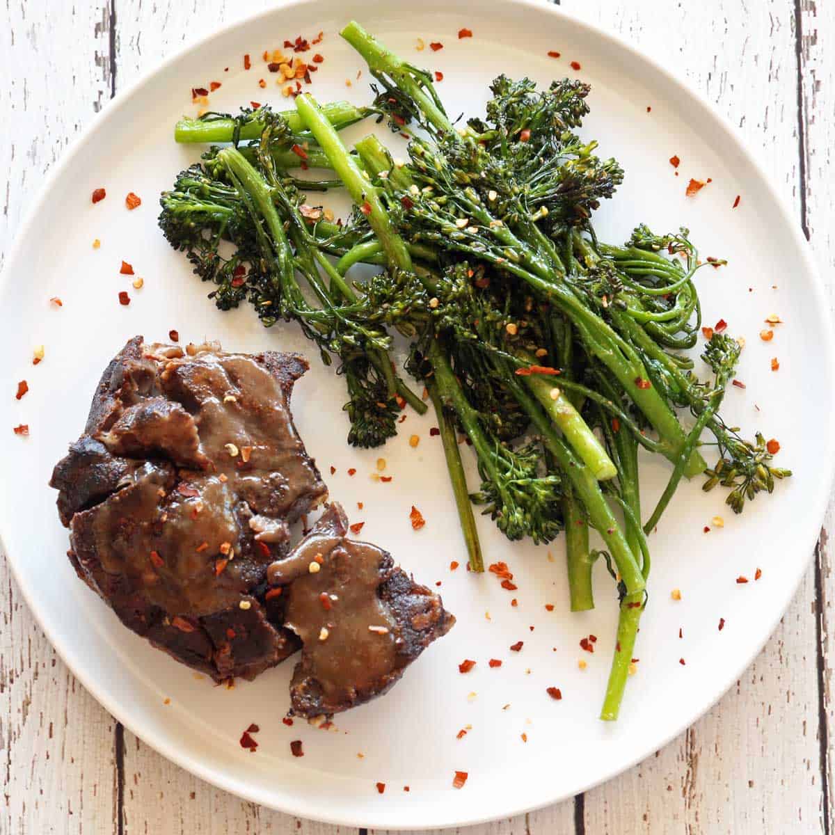 Roasted broccolini is served with beef shanks.