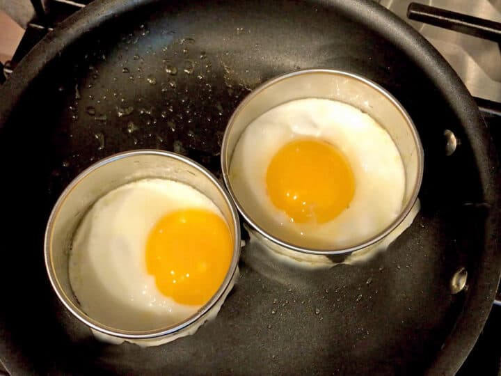 Eggs are cooking in a skillet.