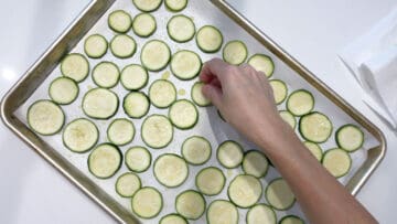 Arranging the zucchini slices on the pan.