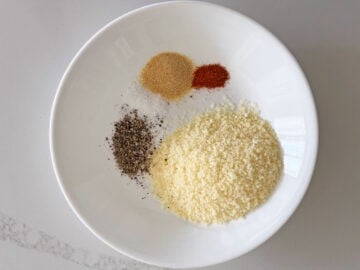 Grated parmesan and spices in a bowl.