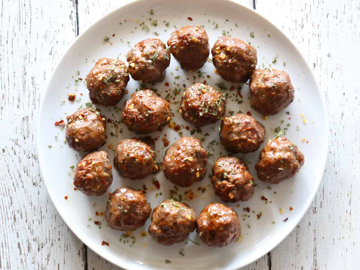 Keto meatballs (without glaze) are served on a white plate.
