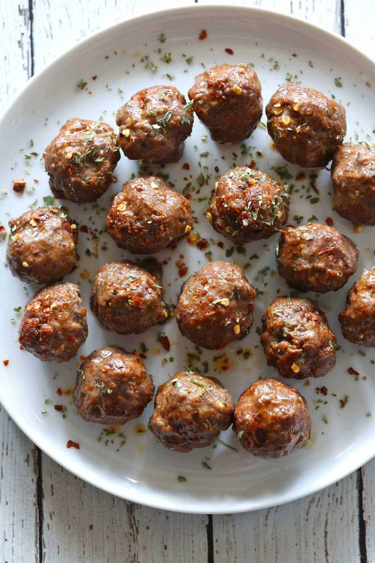 Keto meatballs are served on a white plate.