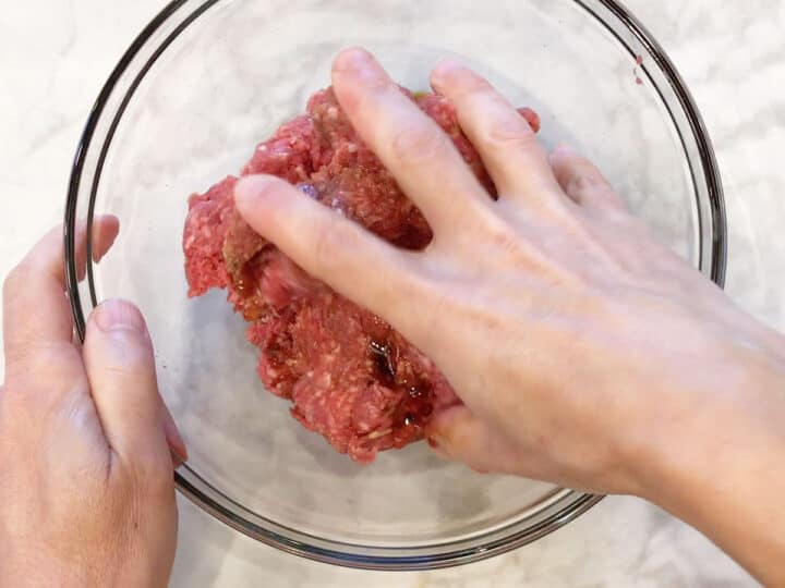 Mixing the meatball ingredients.