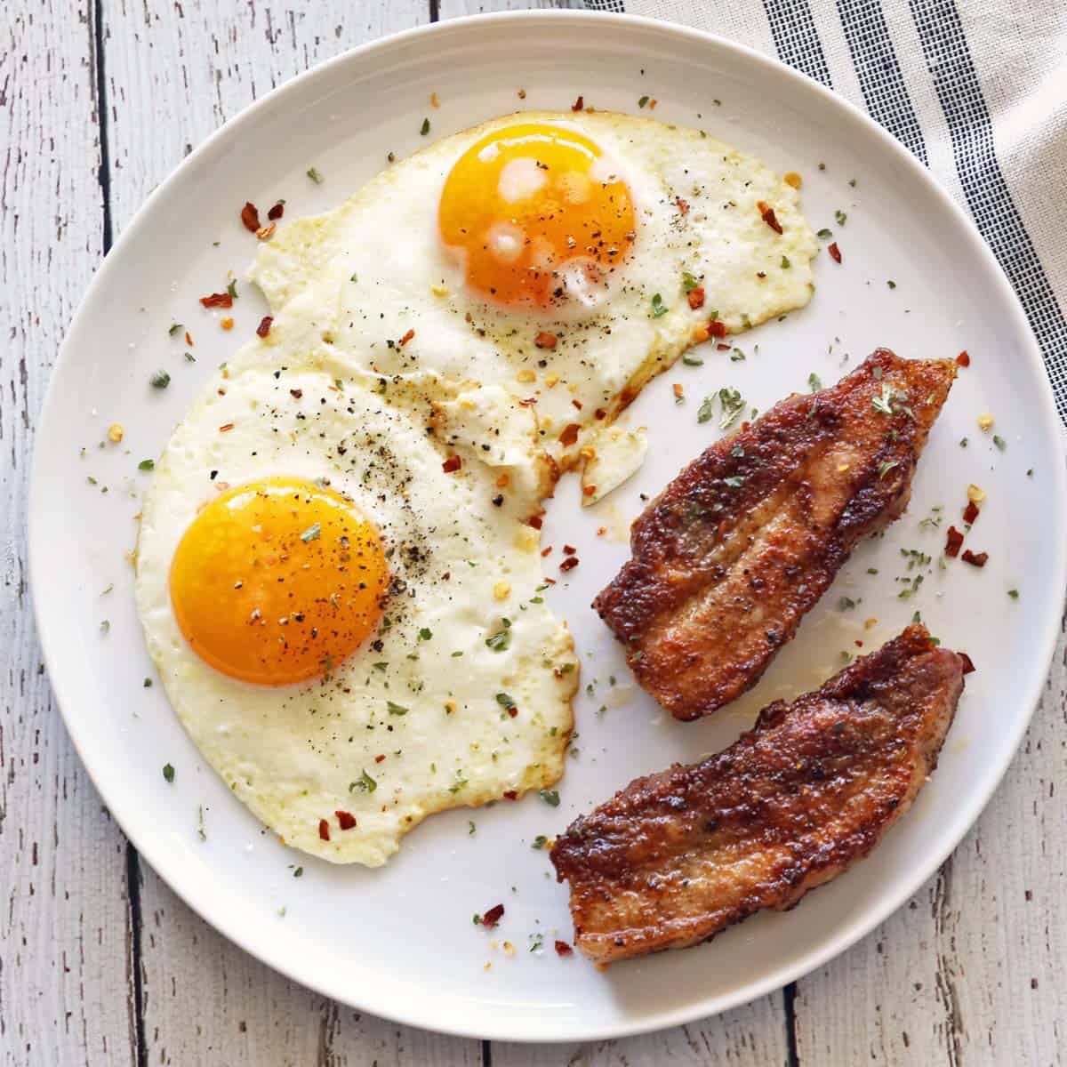 Pork belly is served with eggs for breakfast.