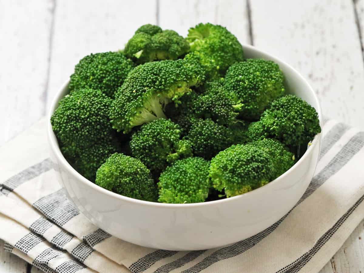Steamed broccoli in a white bowl.